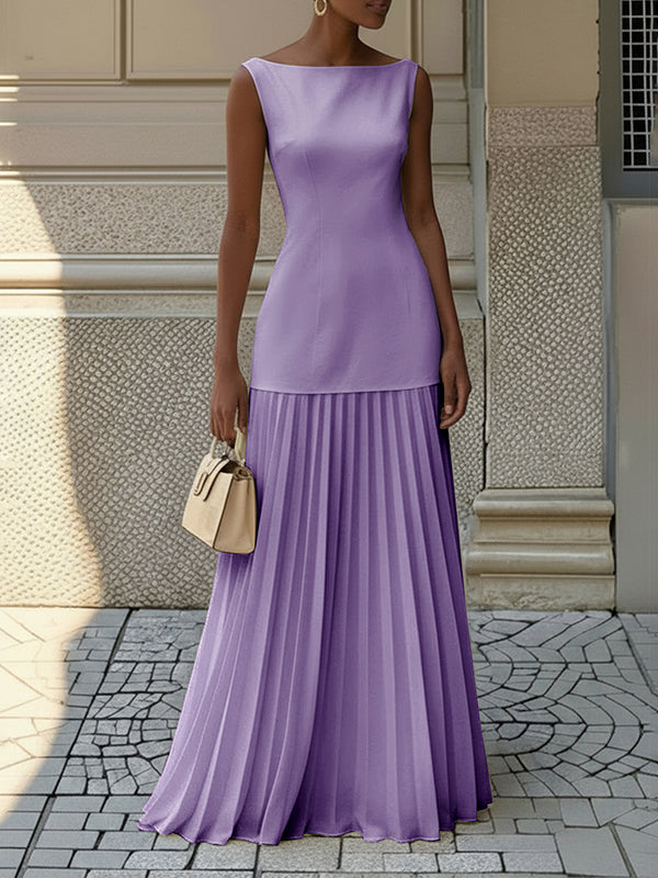 Woman wearing a sleeveless boat neck maxi dress with a knife-pleated drop-waist skirt