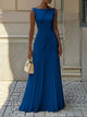 Woman wearing a sleeveless boat neck maxi dress with a knife-pleated drop-waist skirt