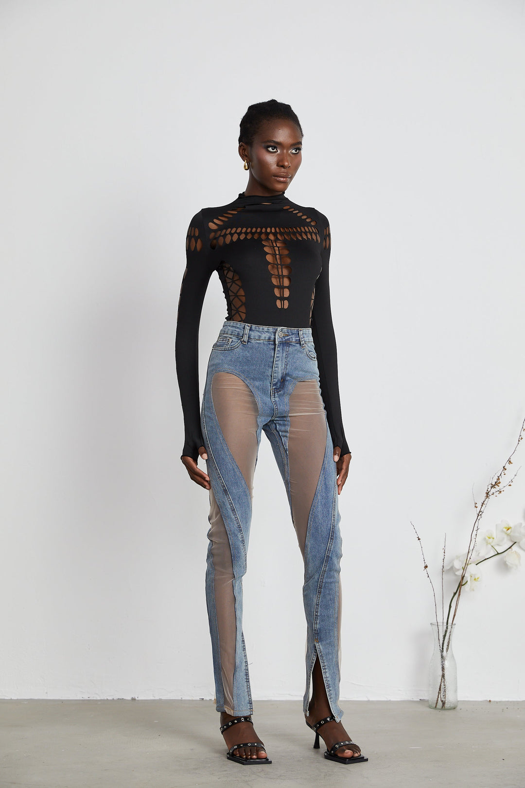 Women's blue jeans with sheer mesh panels at hips and thighs, high rise, fitted silhouette