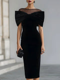 Black velvet midi dress with sheer neckline and oversized bow