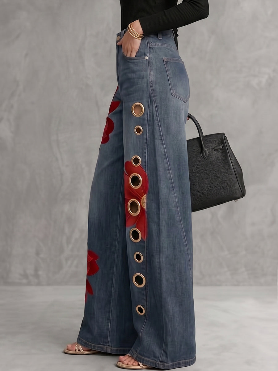 Women's wide leg blue jeans with red floral print and gold grommet details, high waisted