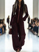 Women's wide-leg jumpsuit with stand collar and front zip, shown in burgundy and pink