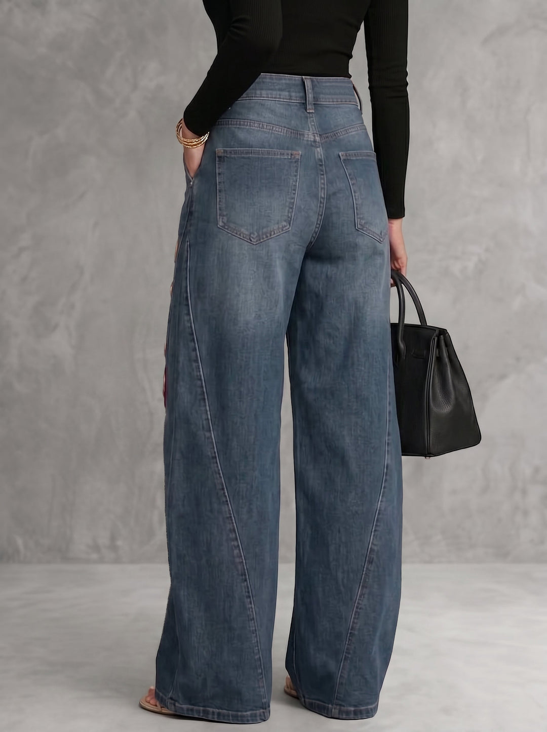 Women's wide leg blue jeans with red floral print and gold grommet details, high waisted