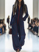 Women's wide-leg jumpsuit with stand collar and front zip, shown in burgundy and pink