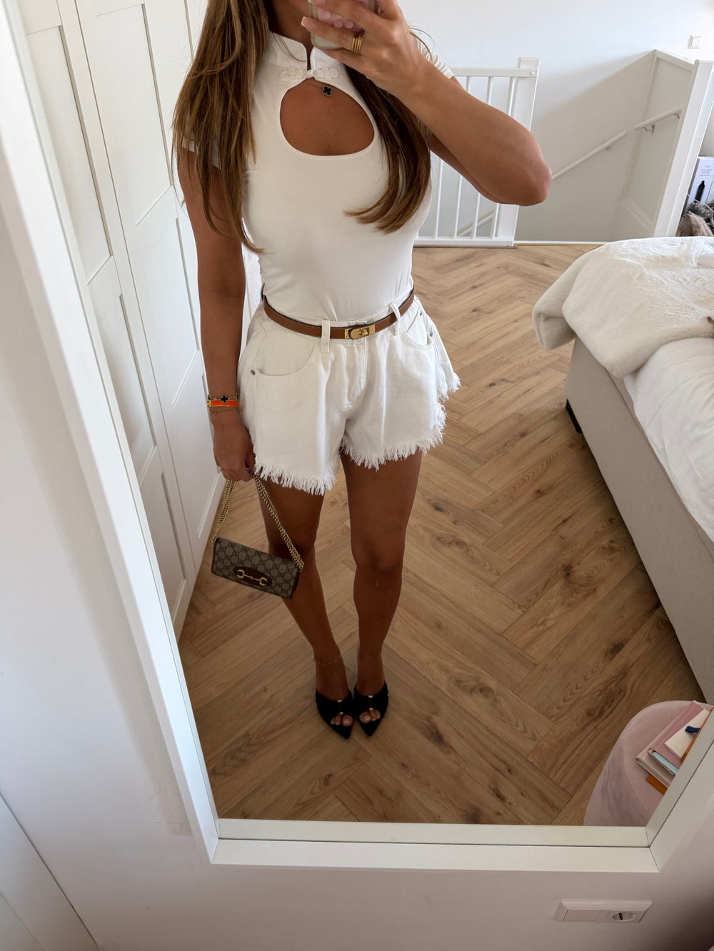 Women's white denim shorts with frayed hem edges and five-pocket styling