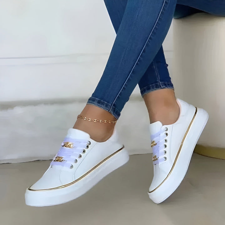 Women's low-top lace-up sneakers with decorative gold trim