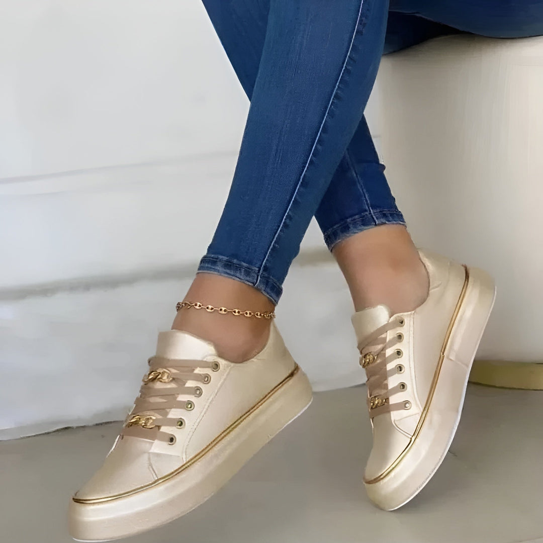 Women's low-top lace-up sneakers with decorative gold trim