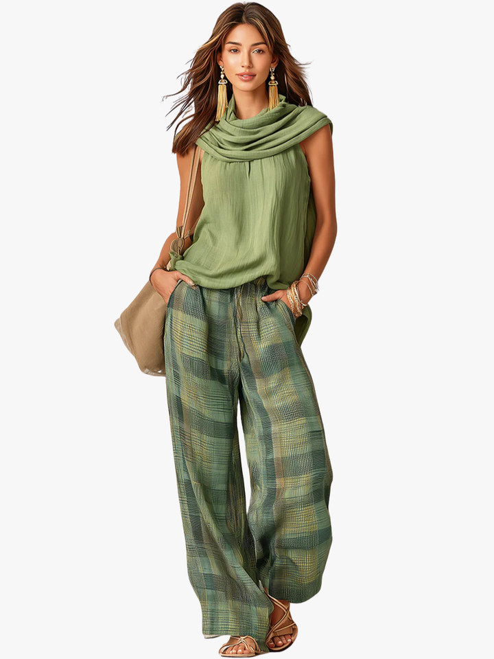 Women's sage green cowl neck top with green and gold checkered wide-leg trousers