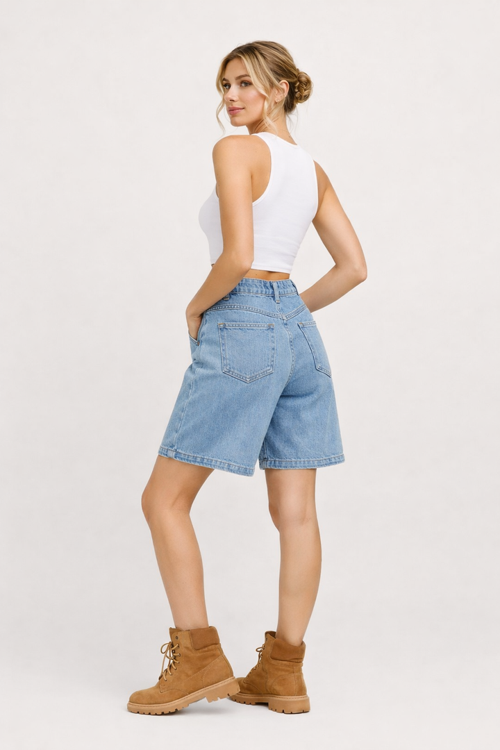 Women's high-rise wide-leg denim bermuda shorts in blue and black, shown with white tank top