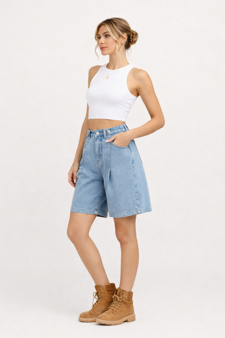 Women's high-rise wide-leg denim bermuda shorts in blue and black, shown with white tank top