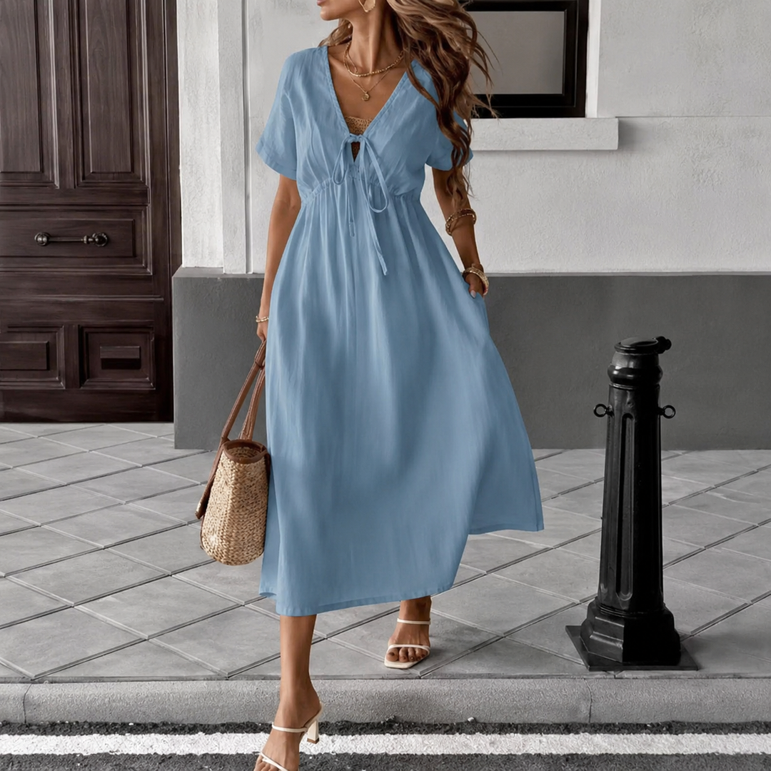 Women's white flowing maxi dress with V-neck tie-front and short puffed sleeves