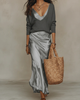 Women's V-neck midi dress layered with a long-sleeve sweater