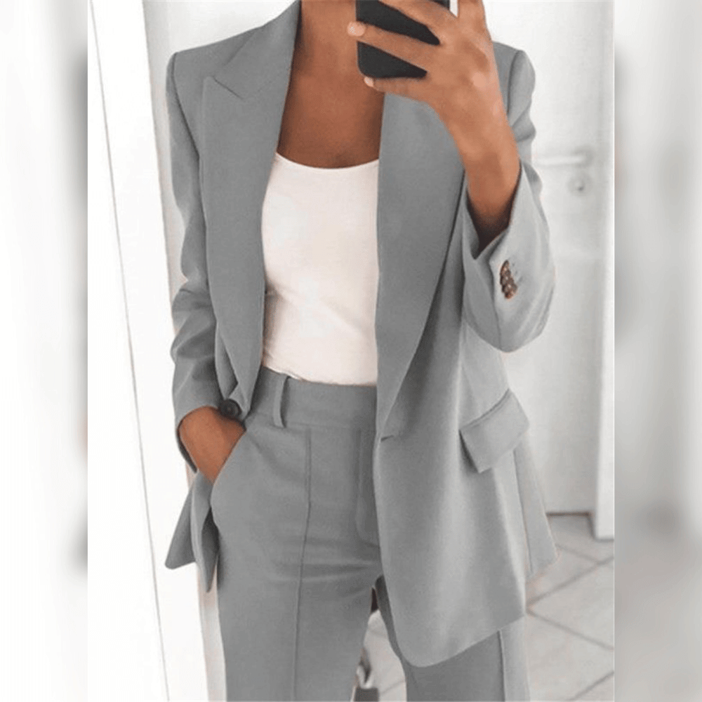 Women's two-piece tailored suit in black and blue, shown with white camisole layered underneath.