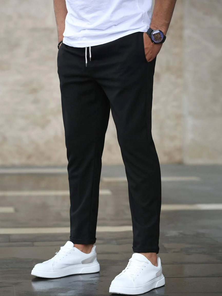 Men's slim-fit jogger pants in grey and olive green, shown with drawstring waist and tapered leg