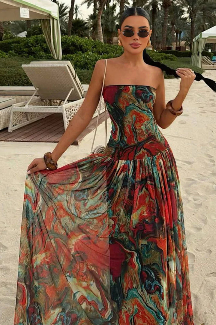 Woman wearing a strapless marbled swirl print maxi dress with a full gathered skirt
