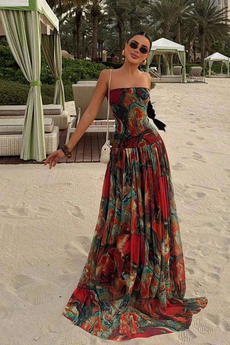 Woman wearing a strapless marbled swirl print maxi dress with a full gathered skirt