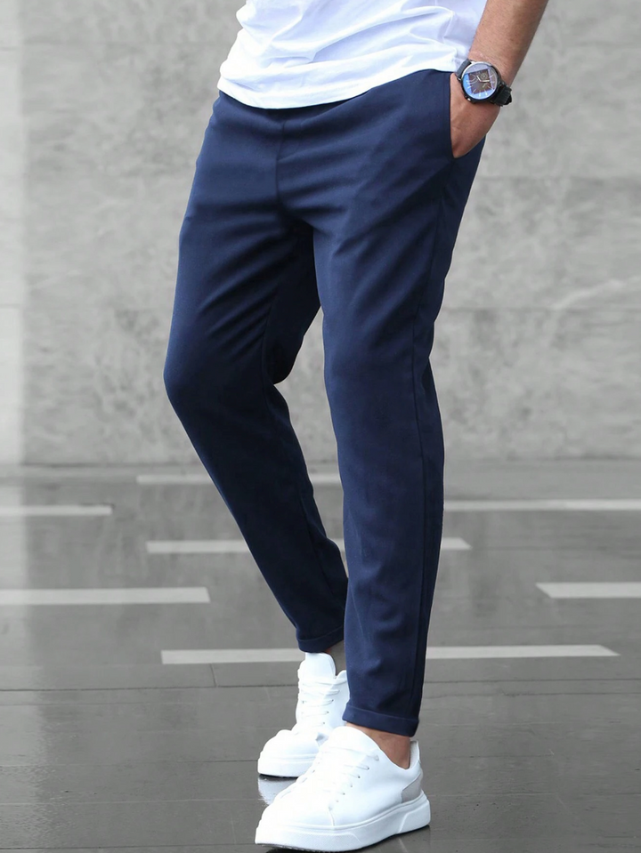 Men's slim-fit jogger pants in grey and olive green, shown with drawstring waist and tapered leg