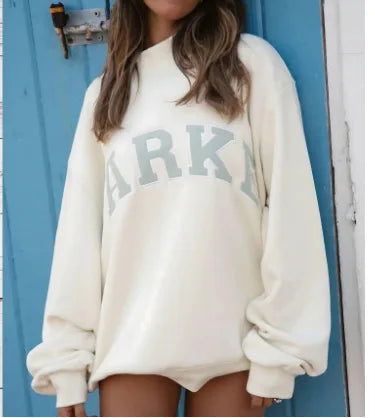 Woman wearing a pink cropped graphic sweatshirt and matching shorts set