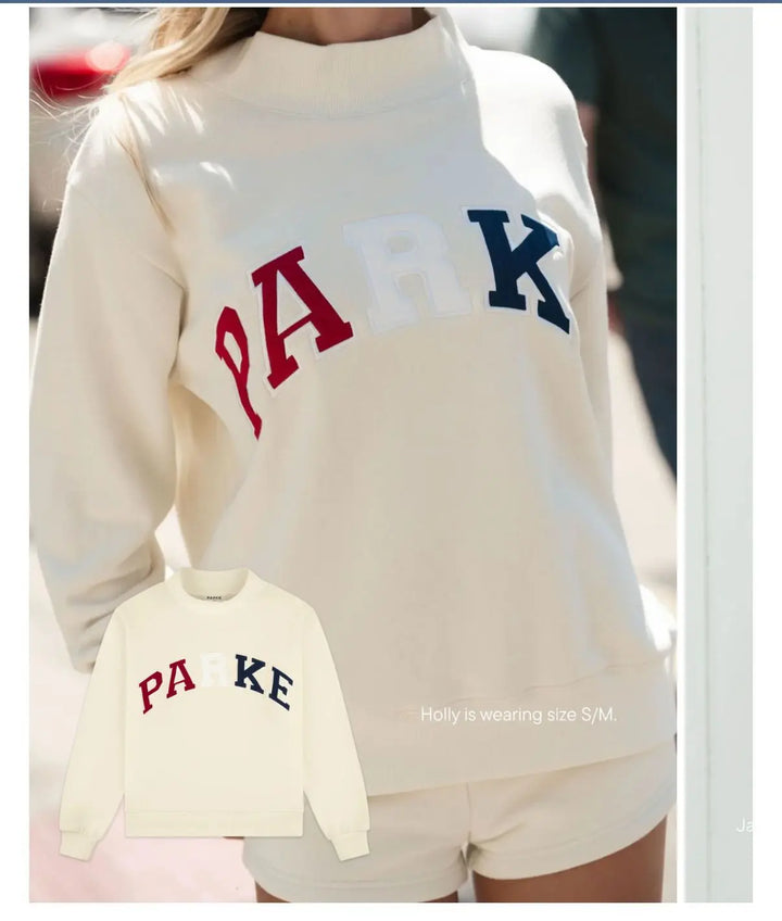 Woman wearing a pink cropped graphic sweatshirt and matching shorts set