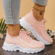 Women's white and black lace-up athletic shoes with perforated mesh upper