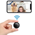 Small black spherical wireless camera with magnetic mount, shown in hand and mounted on surfaces, displaying live video feed on smartphone