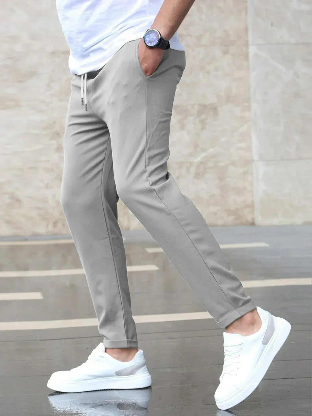 Men's slim-fit jogger pants in grey and olive green, shown with drawstring waist and tapered leg