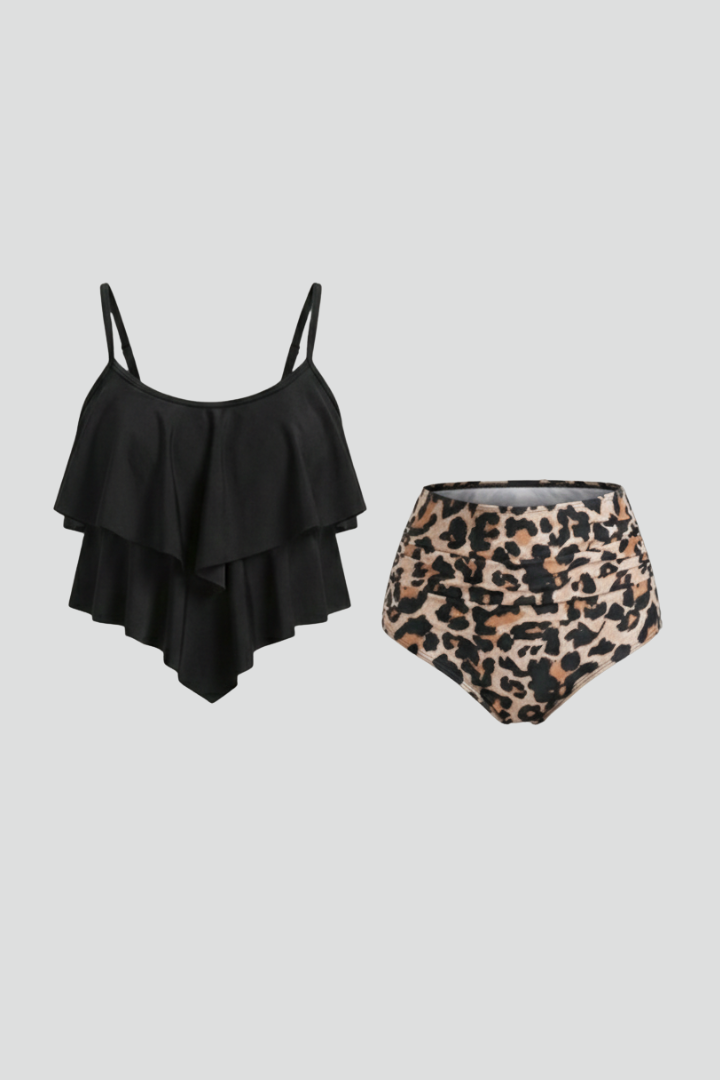 Woman wearing black ruffle tankini top with high-waist printed bottom
