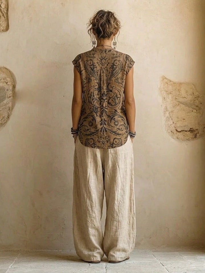 Women's three-piece set with grey-brown button shirt, patterned wrap top, and cream wide-leg trousers