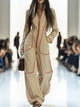 Women's wide-leg jumpsuit with stand collar and front zip, shown in burgundy and pink