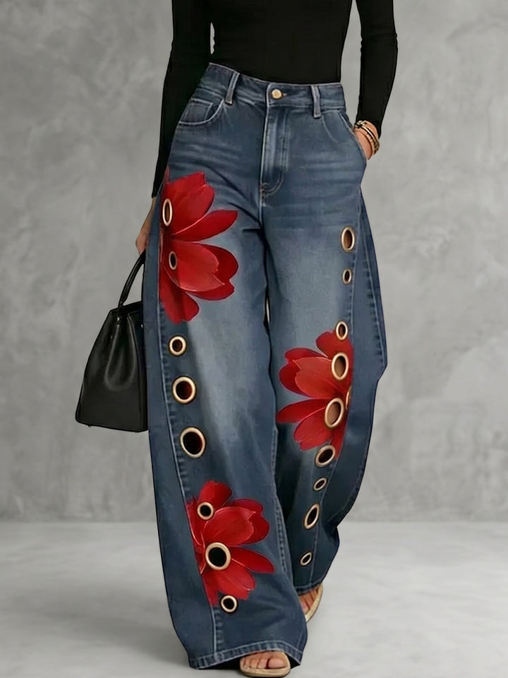 Women's wide leg blue jeans with red floral print and gold grommet details, high waisted