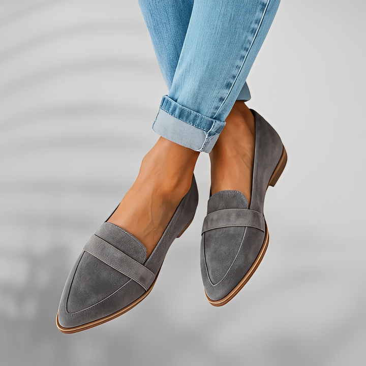 Pair of pointed-toe suede loafers with a penny saddle strap and a low heel