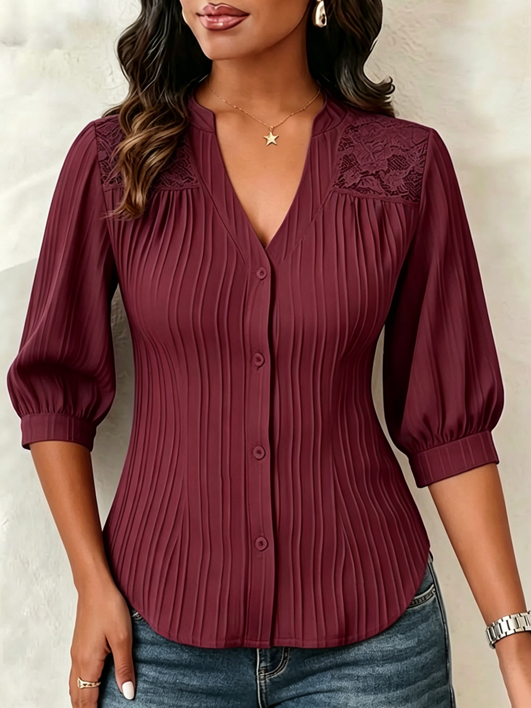 V-neck blouse with vertical pleats, lace shoulder panels, and puffed three-quarter sleeves