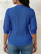 V-neck blouse with vertical pleats, lace shoulder panels, and puffed three-quarter sleeves