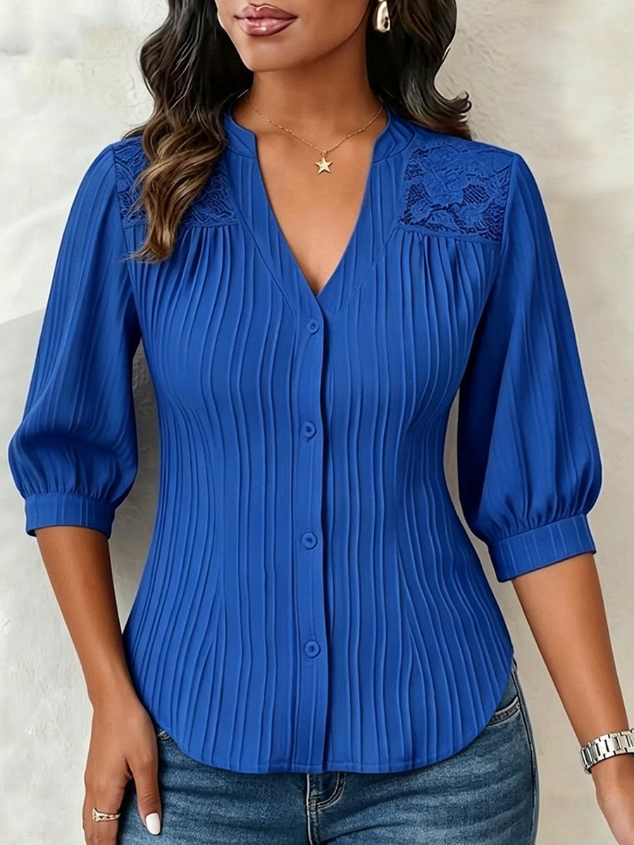 V-neck blouse with vertical pleats, lace shoulder panels, and puffed three-quarter sleeves