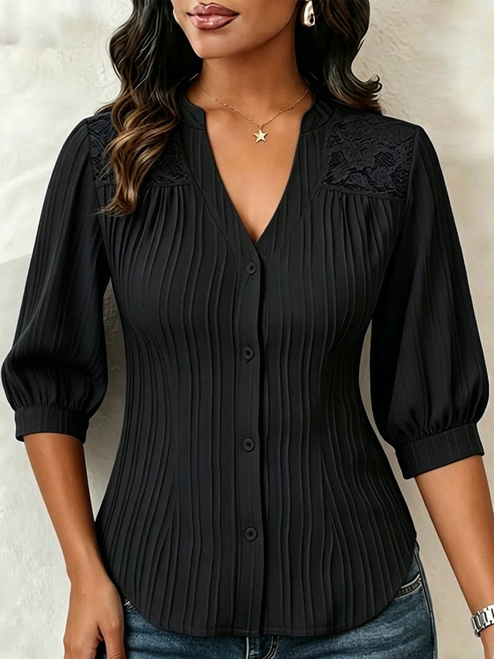 V-neck blouse with vertical pleats, lace shoulder panels, and puffed three-quarter sleeves
