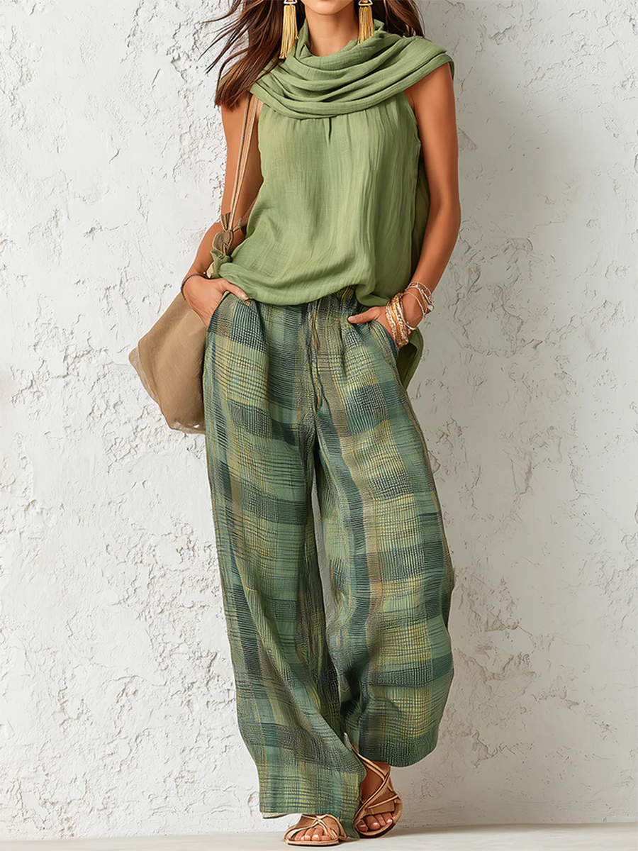 Women's sage green cowl neck top with green and gold checkered wide-leg trousers