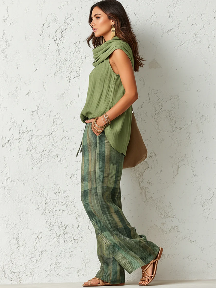 Women's sage green cowl neck top with green and gold checkered wide-leg trousers