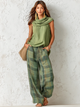 Women's sage green cowl neck top with green and gold checkered wide-leg trousers