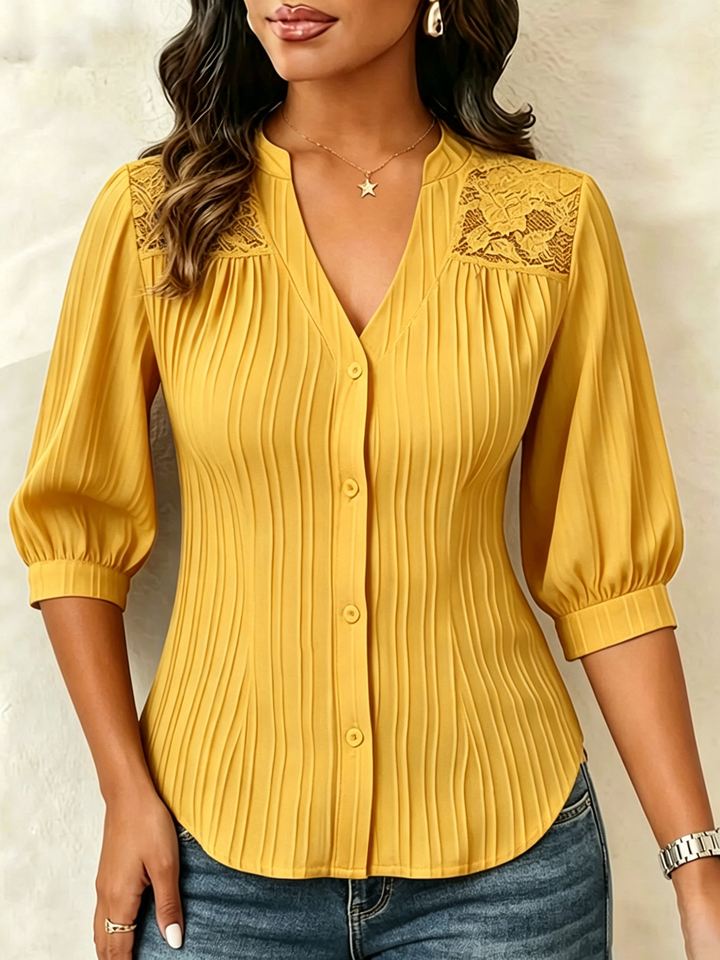 V-neck blouse with vertical pleats, lace shoulder panels, and puffed three-quarter sleeves