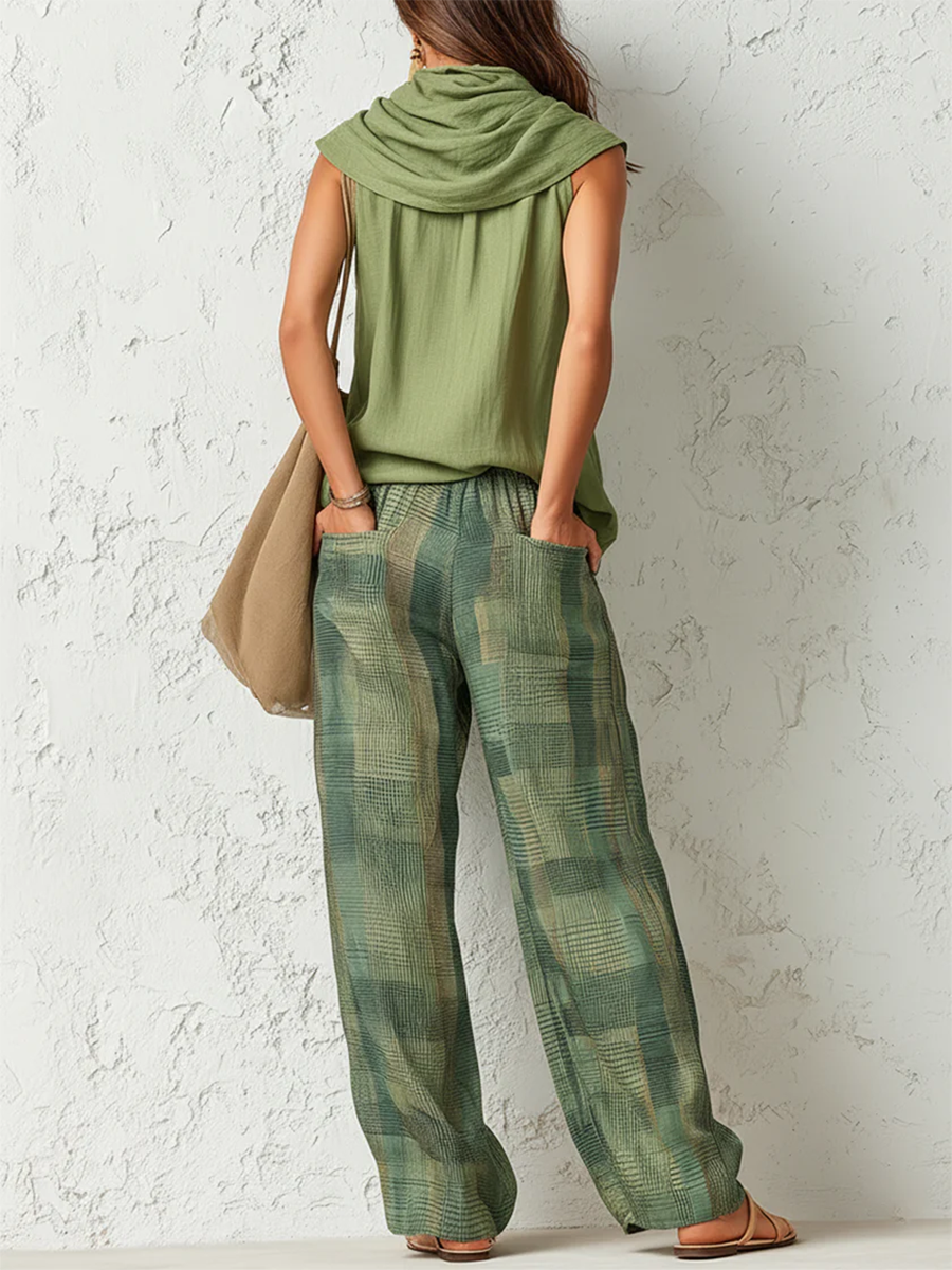 Women's sage green cowl neck top with green and gold checkered wide-leg trousers