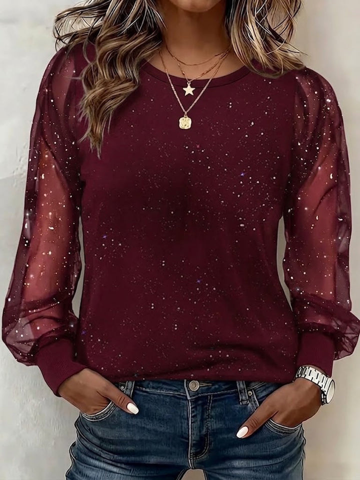 Women's sheer mesh top with glitter star detail and long lantern sleeves, shown in wine and black