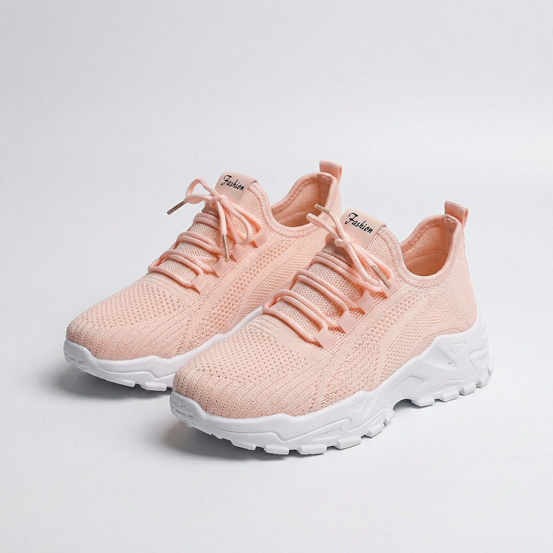 Women's white and black lace-up athletic shoes with perforated mesh upper
