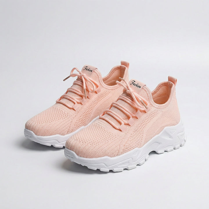 Women's white and black lace-up athletic shoes with perforated mesh upper