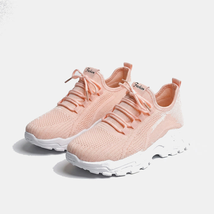 Women's white and black lace-up athletic shoes with perforated mesh upper