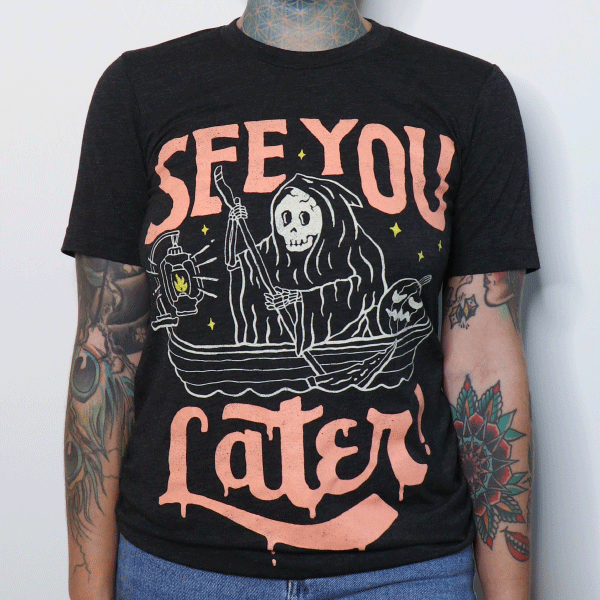 Black crew neck t-shirt with orange and cream graphic print of hooded figure in boat