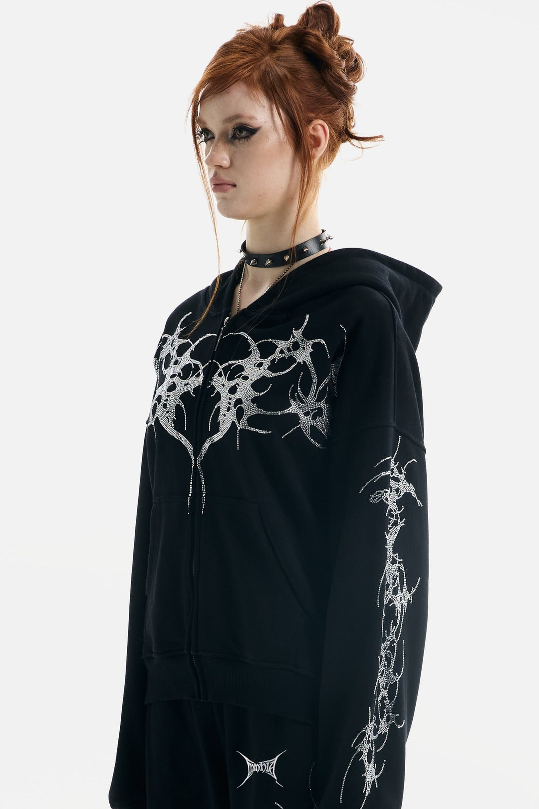 Women's black zip-up hoodie with rhinestone wing and thorn graphics