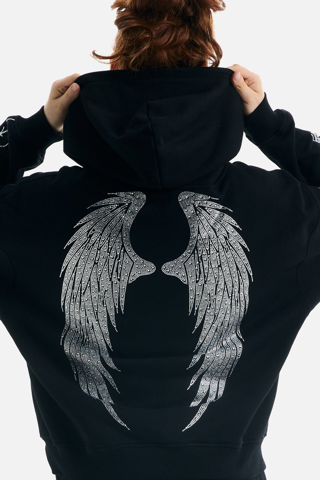 Women's black zip-up hoodie with rhinestone wing and thorn graphics