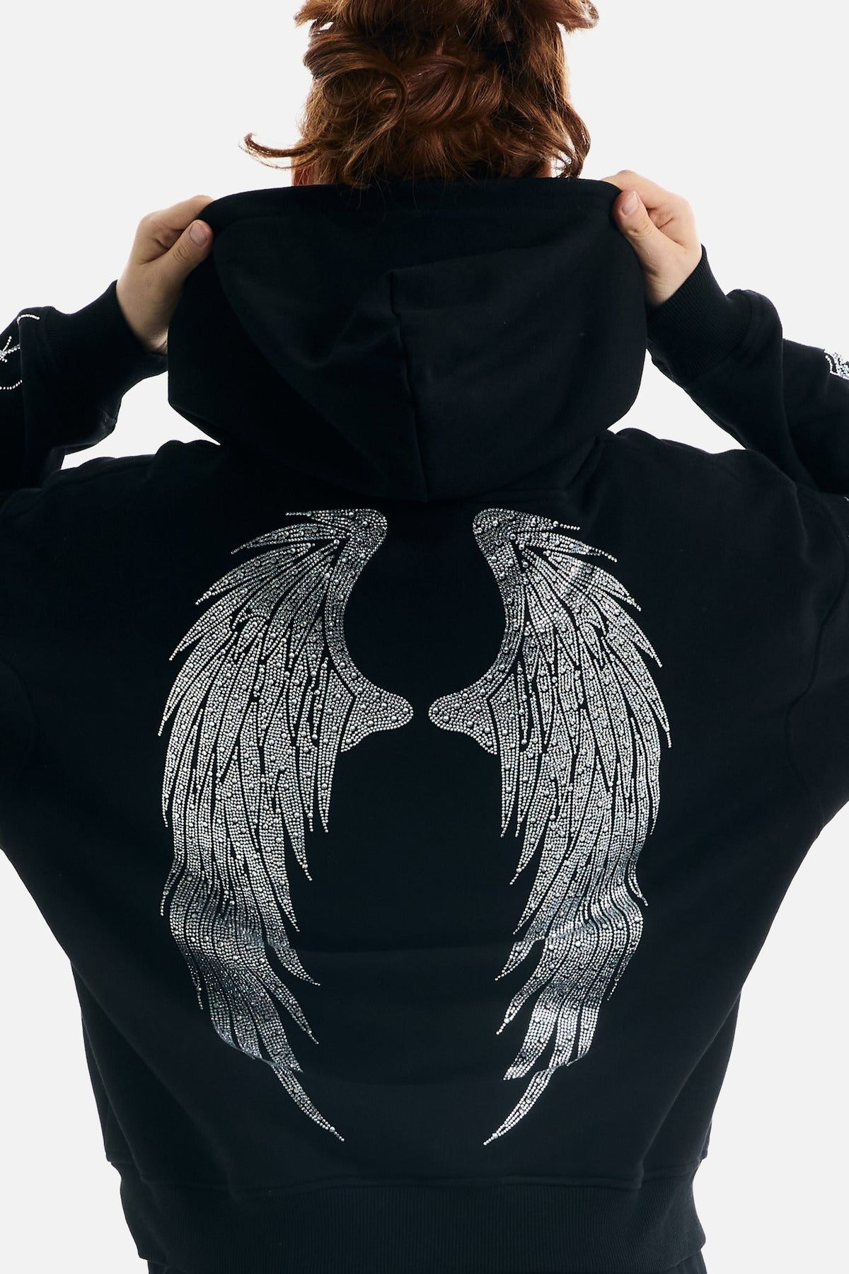 Women's black zip-up hoodie with rhinestone wing and thorn graphics